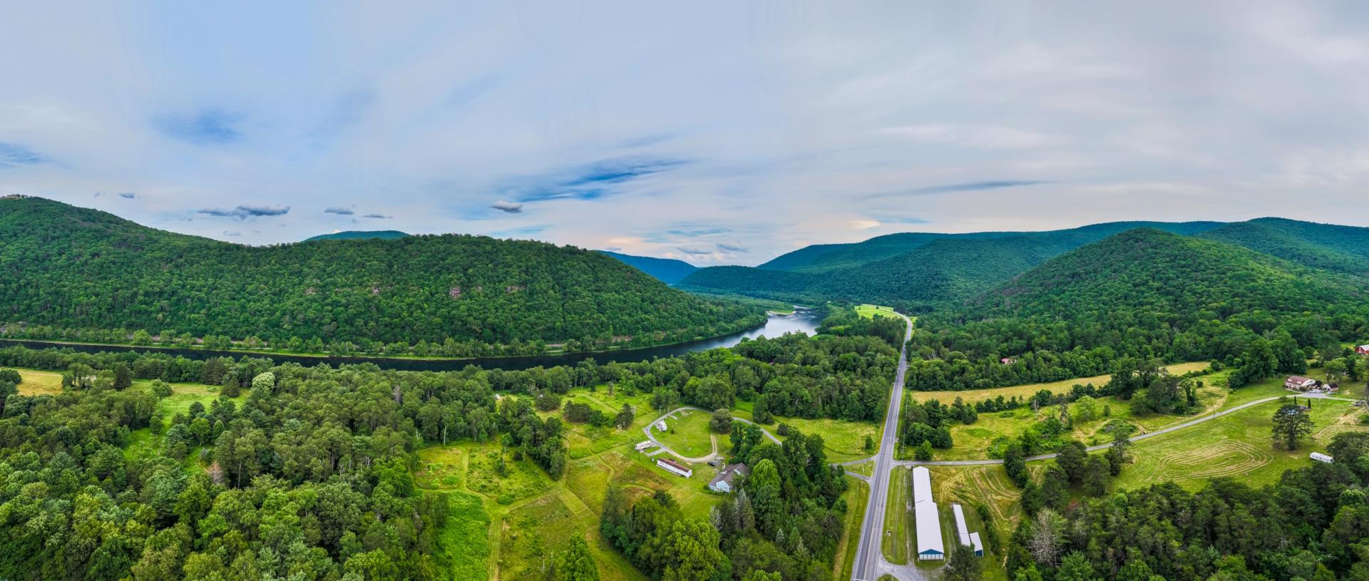 An aerial drone shot of the campground and surrounding mountains and river